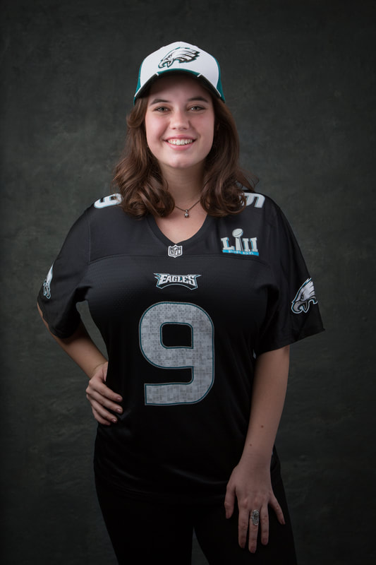 senior portrait girl in football jersey